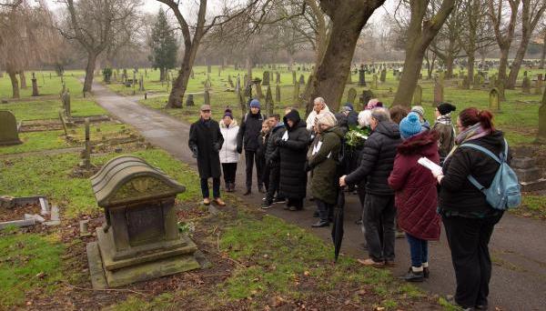 A group of people on a tour in a cemetery