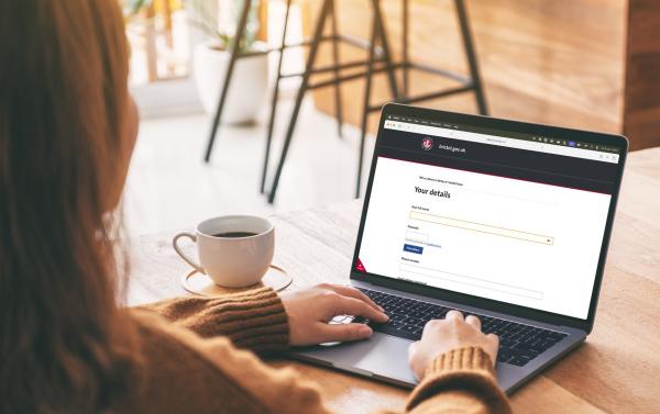 A person sat at a desk using a laptop