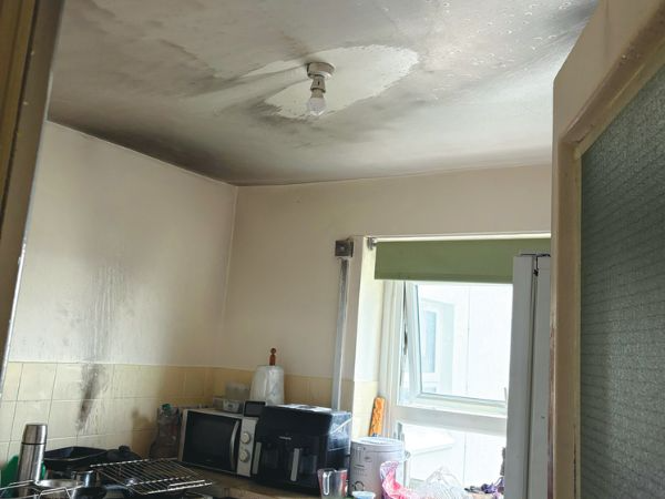 Photos shows the after effects of a small kitchen fire - small amounts of water damage from the sprinkler and smoke marks from the fire