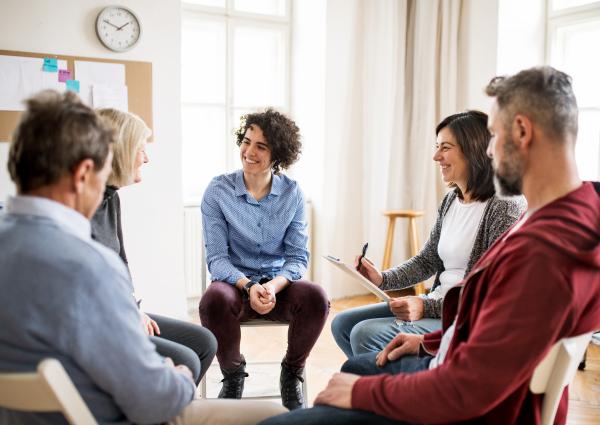 A group of people sat in a circle having a discussion