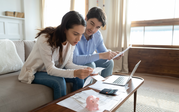 a couple sat discussing over financial documents 
