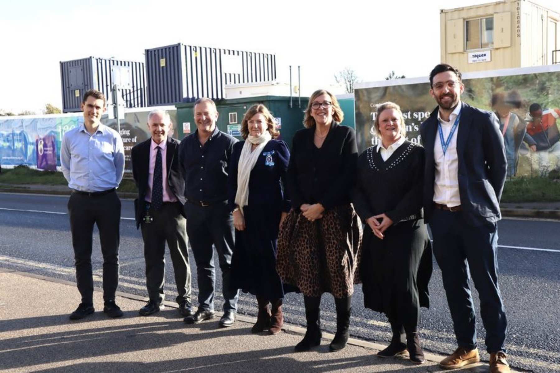 A group of people in front of the Cambridge Children's Hospital site on a visit